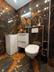 a bathroom with a toilet and a sink and a mirror at L'Écrin Secret Romantic Love Room & Private Spa in Ambilly