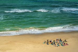 a group of people on a beach near the ocean at Modern 4-Level Townhouse for 8 Free Parking Bournemouth in Bournemouth