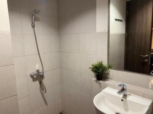 a bathroom with a shower and a sink at Cozy Studio Bintaro Icon Emerald by alonelyroom in Pondokaren