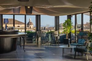 a bar with chairs and a view of a city at Palace Catania | UNA Esperienze in Catania