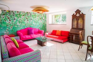 a living room with pink couches and a table at Villa Danima in Capri