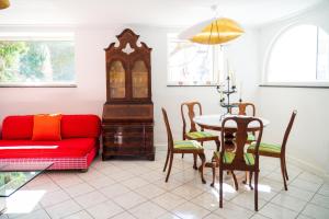 a living room with a red couch and a table at Villa Danima in Capri
