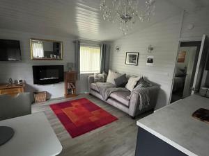 a living room with a couch and a chandelier at No 4 Dane Park in Lymington