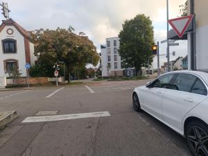 a white car parked at an intersection in a street at Unterkunft am Bahnhof Herrenberg in Herrenberg