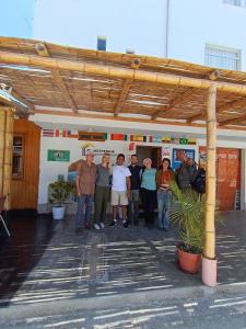 a group of people standing in front of a building at HOSPEDAJE WELCOME PARACAS peru in Paracas