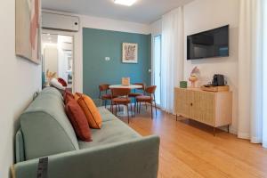 a living room with a couch and a table at Essenza INN Luxury Apartaments in Pescara