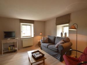 a living room with a couch and a table at Holiday Home in Bullange with Sauna in Bullange