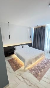a bedroom with a bed with a rug on the floor at VV Luxe in Laknas +10 photos
