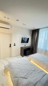 Ένα ή περισσότερα κρεβάτια σε δωμάτιο στο VV Luxe