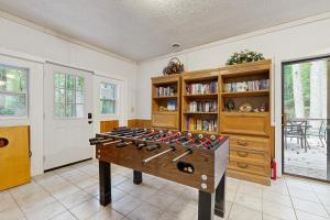 a large room with a table with weapons on it at Brook Hollow in Hendersonville