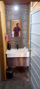 a man taking a picture of a bathroom sink at Depto alem in Leandro N. Alem +4 photos