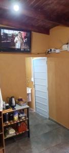 a person taking a picture of a tv on a wall at Depto alem in Leandro N. Alem +4 photos