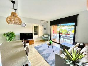 a living room with a couch and a table at FENALS BEACH&CHIC, Boutique Apartament, free parking, full equipped near the beach in Lloret de Mar