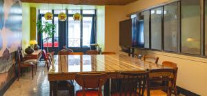 a dining room with a wooden table and chairs at O'fil de soi e in Charlieu