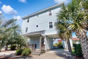 a white house with palm trees in front of it at Bay Watch in Morehead City