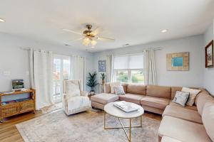 a living room with a couch and a table at Bay Watch in Morehead City