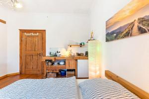 a bedroom with a bed and a kitchen at Apartment zur alten Post in Ulrichstein