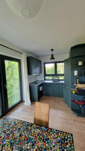a kitchen with blue cabinets and a wooden floor at Seeblick Wohnung,Hausboot in Königs Wusterhausen +12 photos
