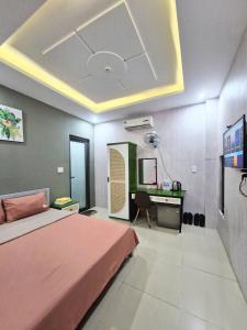 a bedroom with a bed and a desk in it at Hannah House in Vung Tau