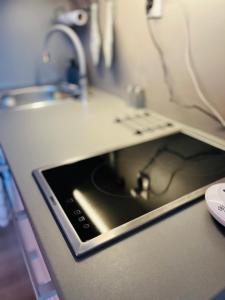 an ipad sitting on a counter in a kitchen at Stylish studio in the heart of Trnava in Trnava +7 photos