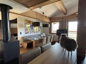 a dining room with a table and a wood stove at Appartement spacieux avec spa, 4 chambres, parking, Les Saisies - FR-1-810-26 in Les Saisies