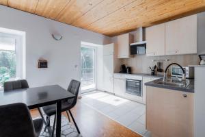 a kitchen with a sink and a table with chairs at homy Alpenlodge in Innerbraz +22 photos