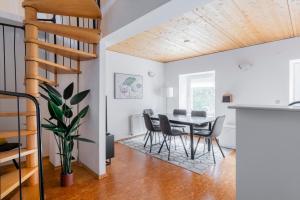 a dining room and kitchen with a table and chairs at homy Alpenlodge in Innerbraz +22 photos