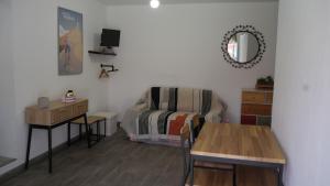 a living room with a table and a chair at Studio de la Luciole in Mouriès