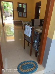 a kitchen with a table and a chair and a rug at DilsBreak HomeStay in Kanyakumari