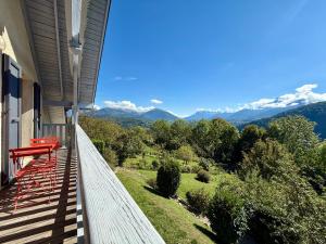 a balcony of a house with a view of the mountains at Un instant près du feu in Ponsonnas