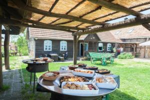 a table with several trays of food on it at Pension Kezele in Graberje Ivanićko