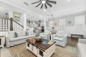 a living room with white furniture and a ceiling fan at Book Me Baby! Take It Easy On 30A in Blue Gulf Beach