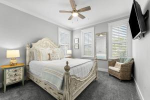 a bedroom with a white bed and a ceiling fan at Book Me Baby! Take It Easy On 30A in Blue Gulf Beach +38 photos