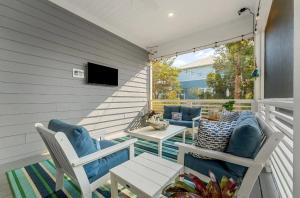 a porch with two chairs and a television on it at Book Me Baby! Take It Easy On 30A in Blue Gulf Beach