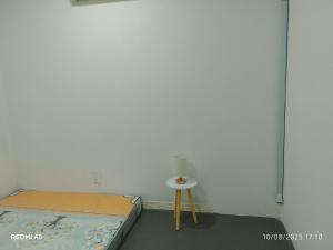 a bedroom with a bed and a small table at D-Fahmi Motel Kinarut in Kota Kinabalu
