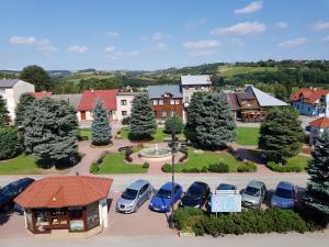 an aerial view of a town with cars parked in a parking lot at Bobowianka in Bobowa
