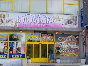 a building with a sign for a restaurant at Bobowianka in Bobowa +1 photo