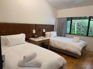 a hotel room with two beds and a window at Twice Central Guest House in Stellenbosch +52 photos