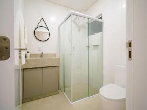 a bathroom with a glass shower and a toilet at Apto c/ churrasqueira a 700m da praia MU3731 in Gravata +18 photos