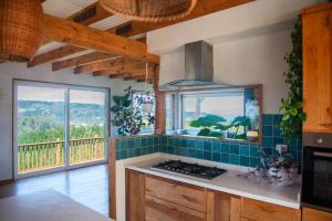 a kitchen with a stove top oven next to a window at Casamar Retreat Buchupureo in Buchupureo