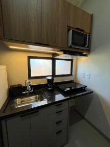 Η κουζίνα ή μικρή κουζίνα στο Apartamento Loft 5 - próximo ao shopping +1 φωτογραφίες