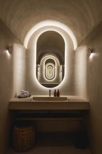 a bathroom with a sink and a mirror at La Villa des Vignes in Saint-Émilion