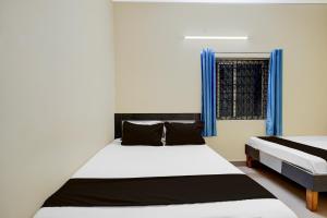 Postel nebo postele na pokoji v ubytování Hotel O Bluestar