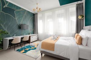 a bedroom with a bed and a desk and a table at Magister Apartmanház in Cserépfalu