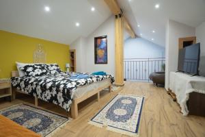 a bedroom with a bed and a flat screen tv at Home Norma in Órma