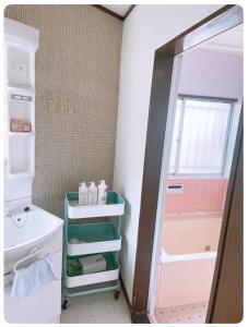 a small bathroom with a sink and a mirror at Karwan House in Wako