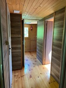 an empty hallway with two doors and wood floors at Pod Magnolią in Targanice +17 photos