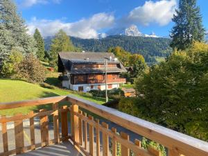 a view from the balcony of a house with a mountain at 2 bedroom apartment close to ski lifts and amenities in Gryon