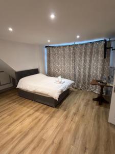 a bedroom with a bed and a wooden floor at The Dublin Packet Room No6 in Holyhead