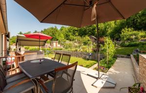 a table and chairs with an umbrella on a patio at 1 Bedroom Lovely Apartment In Gracac in Gračac